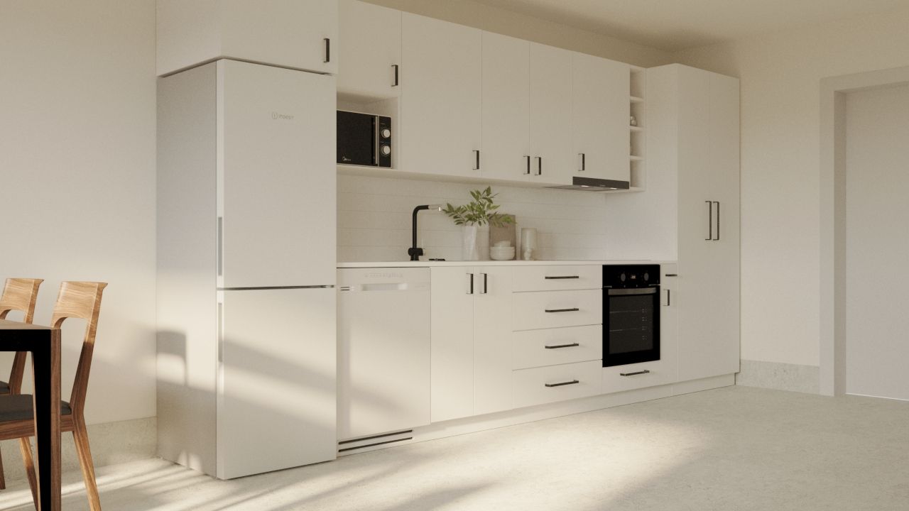 Modernt kök i LSS Nocken med vit inredning, kylskåp och spis.