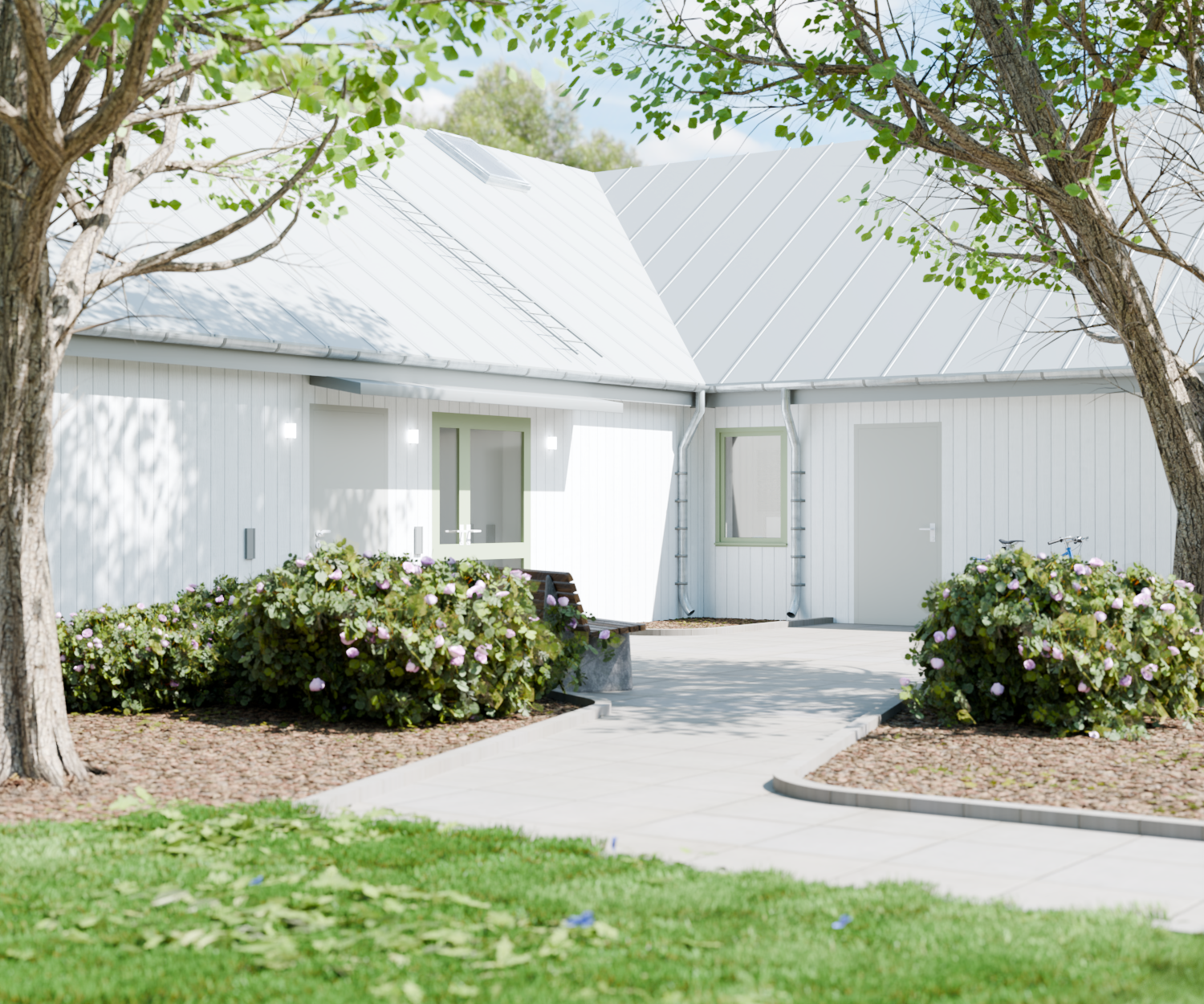 Exteriörvy av entrén till LSS Tureberg med vit fasad och buskar.